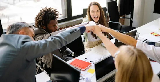 happy employees celebrating with fist bump