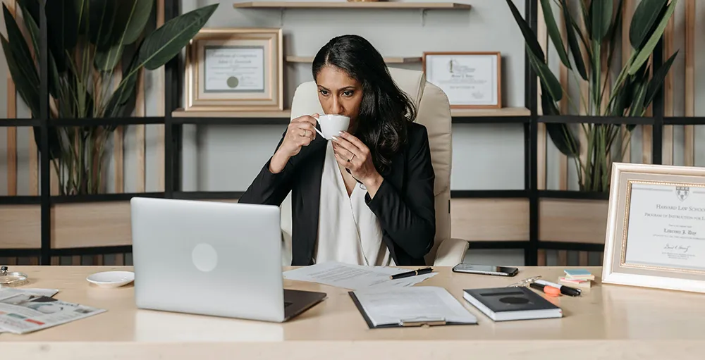 financial aid director drinking coffee in office