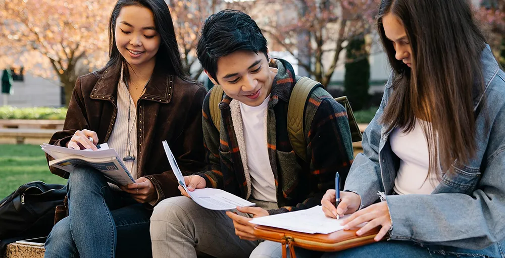 college students studying together outside during financial literacy month