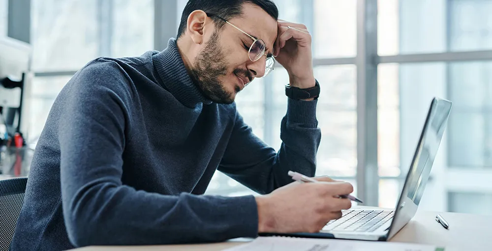tired man sitting at his work desk