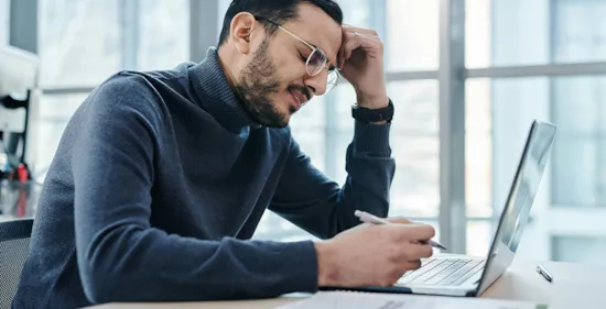 tired man sitting at his work desk