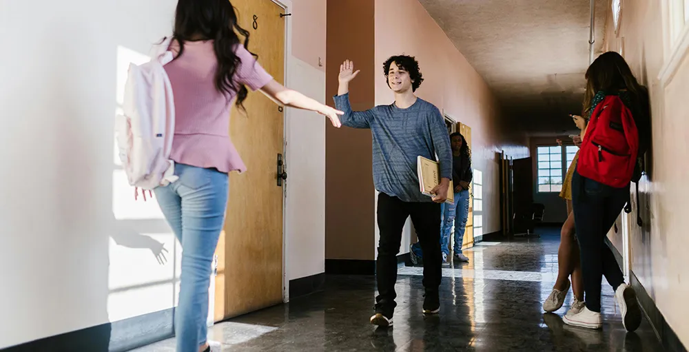 high school students walking in hallway