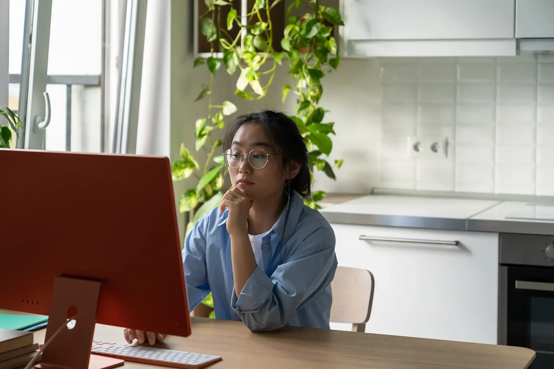 woman using computer in kitchen