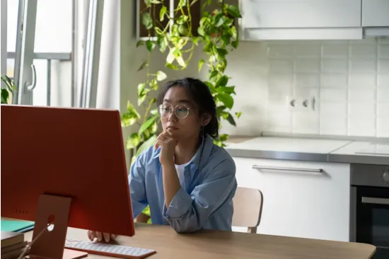 woman using computer in kitchen