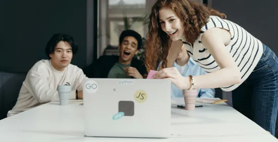 employees laughing looking at laptop