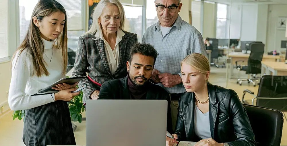 a group of people having a meeting in the office