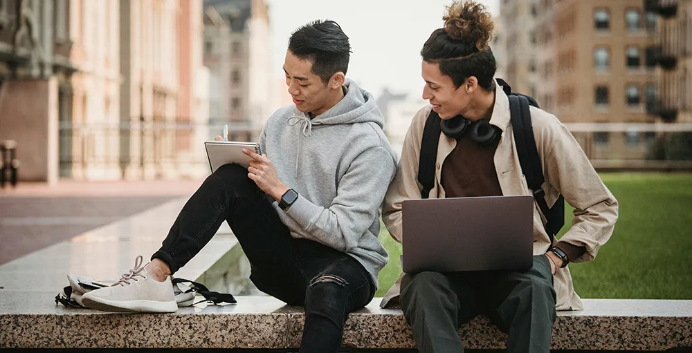 college students sitting outside on campus