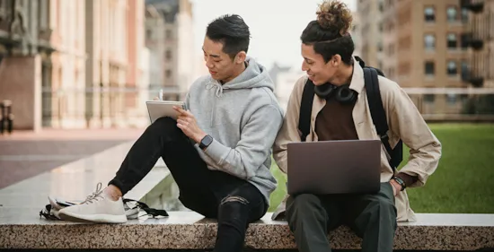 college students sitting outside on campus