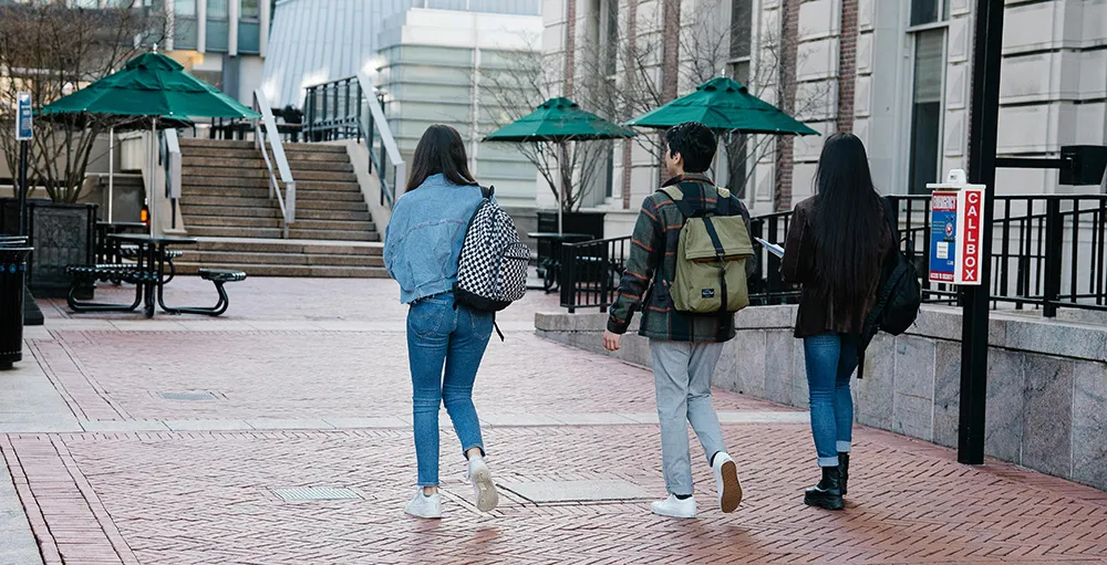 college students walking on sidewalk