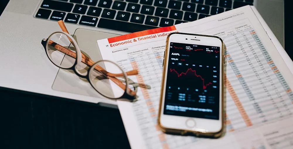 close up of smart phone and economic data