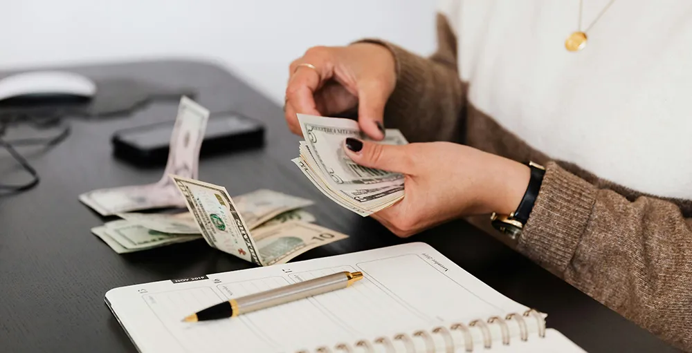 woman counting cash and budgeting